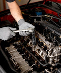 Person using Heavy Duty Badass 29 Piece 1/2 Inch Drive Impact Socket Set Featuring Deep Well CR-V Steel on engine components.