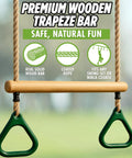 Kids Trapeze Bar With 18 Inch Adjustable Height And Gym Rings For Swing Sets Ninja Warrior Obstacle Course Jungle Gym Playground Attachments Durable Easy Install Backyard Fun with wooden bar and green rings.