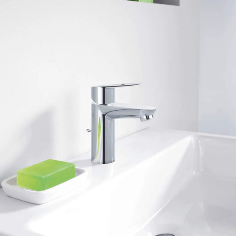 BauLoop Single Handle Bathroom Faucet With 1.5 GPM Flow Chrome Finish And Ceramic Cartridge next to green soap on sink