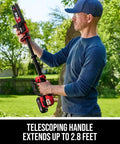 Man using Cordless Brushless 20V 6-Inch Telescoping Chainsaw Kit with telescoping handle extending to 2.8 feet in yard.