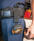 Tradesman Pro Modular Trimming Pouch With Belt Clip For Click Lock System on worker's waist holding tape measure