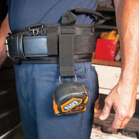 Tradesman Pro Modular Trimming Pouch With Belt Clip For Click Lock System on worker's waist holding tape measure