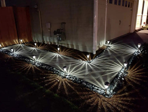 Sweet 6 Pack Silver Solar Path Lights With Glass Lens And Metal Ground Stakes casting star patterns on a walkway, 2023 design