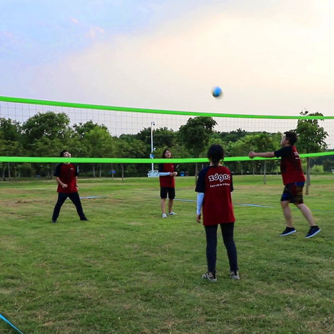 People playing with Portable Backyard Volleyball Set With Durable Net All Weather Construction Includes Pump Wrap Yarn Volleyball Boundary Lines Carry Bag Classic Blue Green Easy Setup For Instant Play