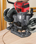 Built Tough Aluminum Plunge Router Base Bracket Replacement For Compact Palm Routers With Effortless Quick Lock Setup and Ridiculously Fine Depth Tweaking For Serious Builders, showing a router in use.