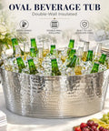 Armored XL Insulated Beverage Tub For Parties, Double Wall Stainless Steel Ice Bucket filled with bottles on a table.