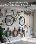 16 Pack Garage Hooks Set Durable Wall Mount Storage System with Heavy Duty Industrial Hangers for bikes, tools, ladders, mops and brooms, extension straps, 100 lbs capacity, orange installed in a garage.