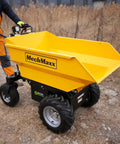 Electric Mini Dumper 1100Lbs Capacity Wheel Barrow With 48V Brushless Motor, yellow dump cart on uneven ground.