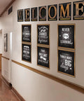 Fresh Industrial Chic Bulletin Board Poster Set Leveling Up Classroom Vibe With Seven Welcome Cutouts And Six Motivational Prints on a wall.