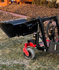 Heavy Duty 42 Inch Mini Skid Steer Dirt Bucket Attachment With Toro Style Mounting shown in a landscape