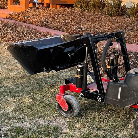 Heavy Duty 42 Inch Mini Skid Steer Dirt Bucket Attachment With Toro Style Mounting shown in a landscape