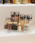 Clear Lazy Susan For Refrigerator And Pantry Cabinet Two Pack 360 Degree Rotating Pull Out Turntable Organizer with spice jars.