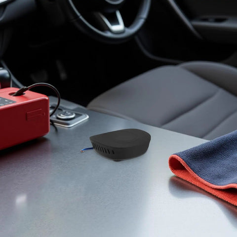 Compact 30 Gram Self Activating Aerosol Fire Extinguisher For Trucks And Cars With Automatic 170 Degree Heat Trigger sits on car console.