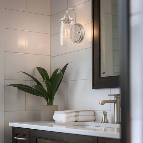 Kira Home Rayne 10" Modern Farmhouse Wall Sconce for Bathroom Vanity, Pack of 2 illuminating a bathroom with clear glass shade.