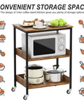 Slick Three Tier Rolling Kitchen Microwave Cart Featuring Rugged Steel Frame For Hella Spacious Storage And Smooth Mobile Coffee Bar Or Living Room Side Table Platform with microwave and cookware.