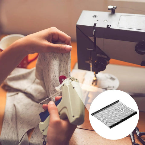 Person using Top Shelf Heavy Duty Plastic Tagging Fasteners For Clothes And Retail 3 Inch Black Label Gun Barbs on fabric.