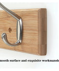 Close-up of Slick Wall Mount Coat Rack With Heavy Duty Hook Rails For Entryway And Mudroom, featuring wood and zinc alloy details.