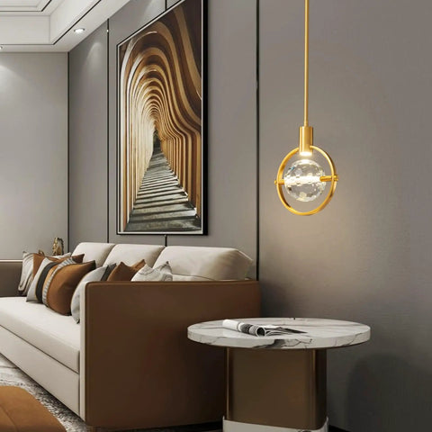 Dope Modern Crystal Pendant Light In Gold Brushed Brass Finish With 4.33 Inch K9 Crystal in a stylish living room setting