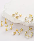 Gold Plated Earring Set For Women 9 Pairs Including Huggie Hoops Planet Ball Flower Dangle Studs Flat Back Cartilage Tragus Earrings For Multiple Piercings Stackable Jewelry Perfect For Everyday Vibe on white stone