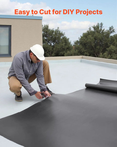 Person cutting Tough As Nails 10 X 15 Ft Roll Roofing With 45 Mil EPDM Rubber Membrane for DIY project on roof.