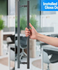 Person opening glass door with Matte Black Ladder Style Push Pull Door Handle Back To Back 36 Inch 900mm Long With 760mm Center To Center 304 Stainless Steel Heavy Duty.