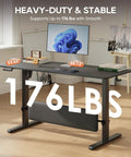 MALOL 56 Inch Electric Standing Desk With Adjustable Footrest Black height adjustable workstation showing digital display and stability support.