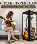 Premium Guitar Display Case With Humidification And Constant Temperature Control beside woman playing guitar on sofa