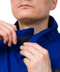 Man adjusting collar of DVALIN Hybrid FR Leather Welding Jacket With Leather Sleeves And Snap Buttons for spark and heat protection
