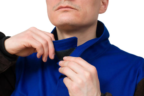 Man adjusting collar of DVALIN Hybrid FR Leather Welding Jacket With Leather Sleeves And Snap Buttons for spark and heat protection