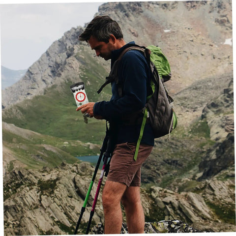 Hiker using Portable Orienteering Compass With Ruler And Mirror High Accuracy Hiking Map Tool For Camping And Travel in mountain landscape.