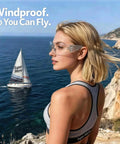 Shop Ready 12 Pack Safety Glasses For The Daily Hustle And Sports, Ansi Z87.1 Rated, worn outdoors with ocean background.
