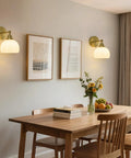 Feasey Vintage Milk Glass Globe Wall Sconce, Mid Century Ribbed Glass Light illuminating a dining area with artwork.