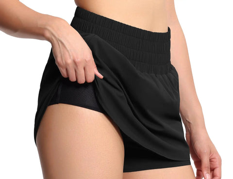 Close-up of black athletic skorts showing elastic waistband and mesh liner, part of Athletic Skorts With Elastic Waistband Quick Dry 4 Way Stretch Fabric Mesh Liner Zipper Pockets Front Ruffle Hem Curved Hem Design Gym Ready Lightweight Training For Running Tennis And Workout Black.