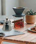 Turkish Style Stainless Steel Coffee Pot And Milk Pot With Lid Wooden Handle Spout Stovetop Butter Melting Pot 250Ml on table