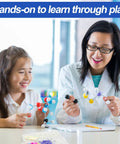 Teacher and student using Ultimate 297 Piece Chemistry Molecule Model Kit for hands-on learning, building 3D atom models.