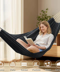 Woman reading in a Cotton Portable Camping Hammock With Tree Straps Up To 660 Lbs Travel Bag Indoor Outdoor Patio Backyard Comfort Fabric Hammock For Relaxation All Season Lounging Anywhere