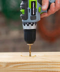 WORKPRO cordless drill with twist drill bit drilling into wood; close-up view showing brand on the drill.