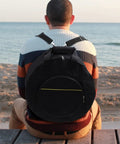 Road Ready Snare Drum Case And Gig Bag With Badass Thickened Padding And Adjustable Shoulder Strap For Smooth Hauling Of Your 14 Or 15 Inch Snare In Sleek Matte Black on beach.