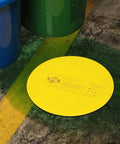 Beefy Heavy Duty Storm Drain Cover For Round Drains Up To 6 Inches Diameter, on concrete near colored bins