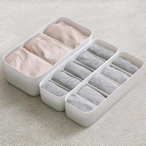 3 Piece Stackable Storage Box Set With Dividers For Bras And Leggings Multi Compartment Drawer Organizer Bin For Underwear Socks Plus Neck Ties, gray bins holding rolled socks and leggings.