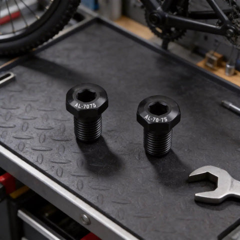 Aluminium Alloy Bike Rear Derailleur Hanger Bolts M10xP1.0 Mounting Screws, black finish on workbench with wrench.