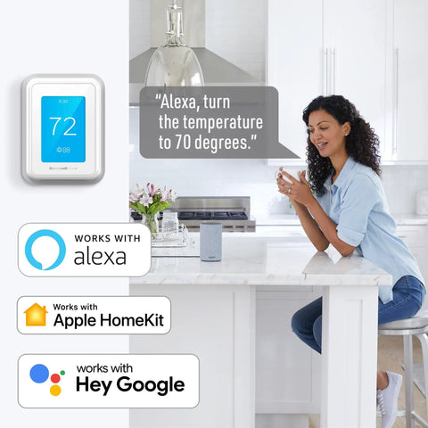 Woman using WiFi Smart Thermostat With Touchscreen Display, Room Sensor Ready, And Alexa And Google Assistant Support in kitchen
