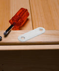 Flat Straight Brace Set 100 Pcs 2.2x0.6in Stainless Steel Shelf Brackets on wood surface with screwdriver