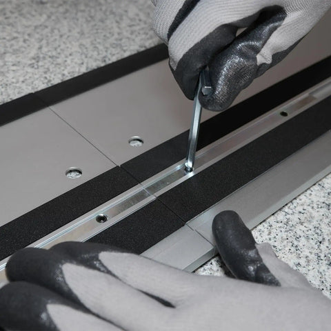 User assembling the 110 Inch Guide Rail Kit Extruded Aluminum Rails Compatible With Track Saw using an Allen wrench.