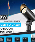 Dusk To Dawn 30W Outdoor LED Spotlight With Photocell Sensor illuminating a flagpole, 3000K warm white, black stake mount design