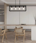Modern Rectangle Black 4 Light Pendant For Dining Room And Kitchen Island Lighting Fixture With Adjustable Height Chains And Easy Install Sleek Linear Cage Farmhouse Ceiling Light over a dining table with chairs.