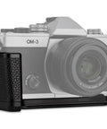 OM System OM 3 Hand Grip Camera Bracket With Arca Swiss Interface shown on an OM-3 camera, textured leather grip detail