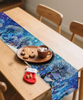 Cozy Linen Christmas Table Runner With Blue Snowy Village Winter Scene For The Fam And Family Holiday Gatherings 13x72 Inches 2D Printed Tabletop Decor That Brings Festive Winter Vibes displayed on wooden dining table with cookies and cocoa