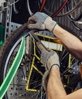 Mechanic installing Two Roll Bike Tire Liner Set for Flat Protection and Puncture Defense on a bicycle wheel with TPU Guard