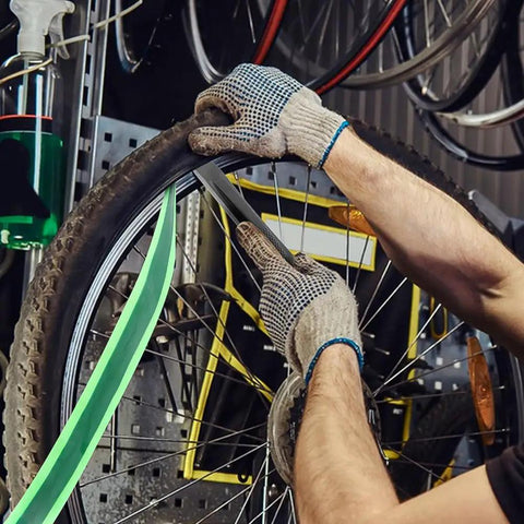 Mechanic installing Two Roll Bike Tire Liner Set for Flat Protection and Puncture Defense on a bicycle wheel with TPU Guard